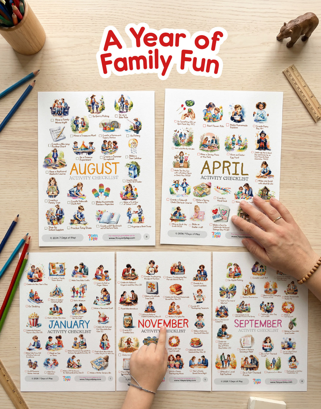 Four seasonal activity calendars on a table with hands interacting with them, titled 'A Year of Family Fun'.