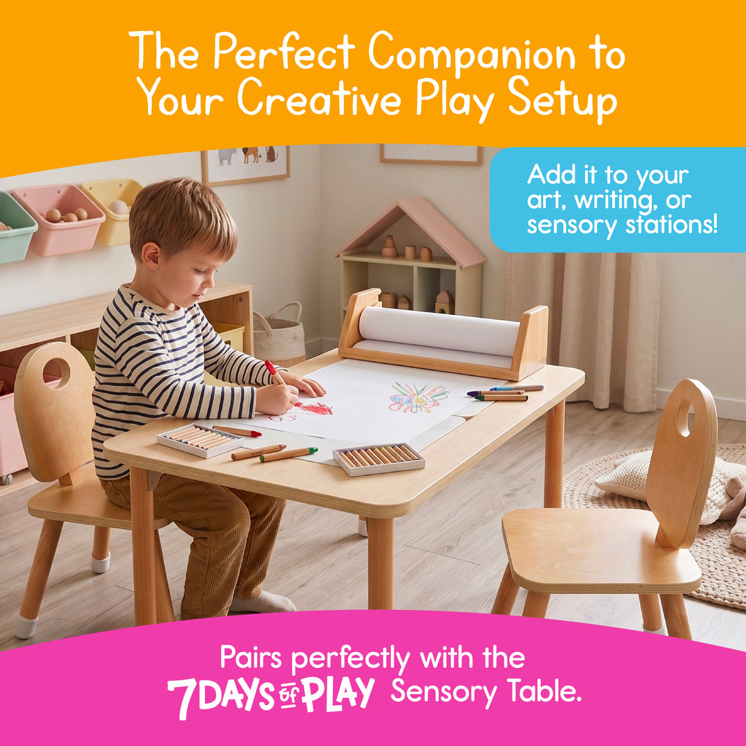 Child drawing at a wooden table with the art paper roll dispenser in a playroom, homeschool or classroom art corner